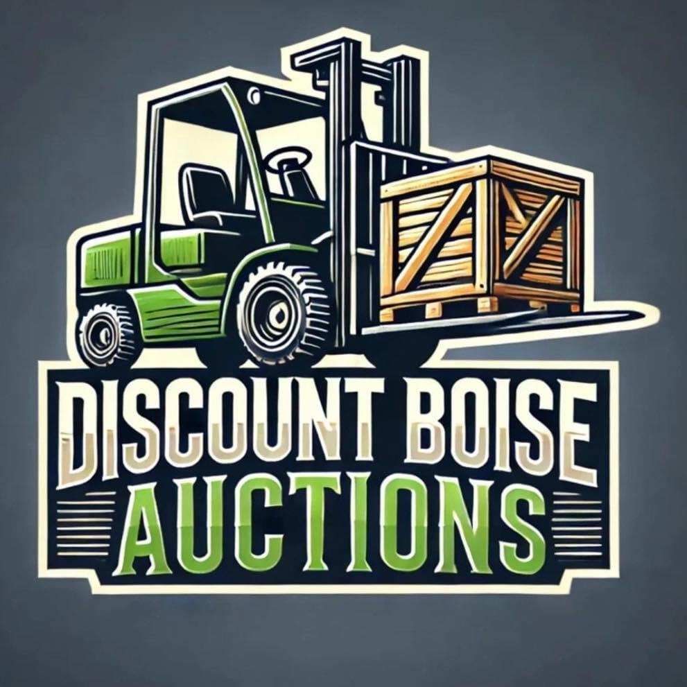 Interior of a large warehouse set up for auctions, with rows of chairs facing a stage, industrial lighting overhead, and various items like furniture and equipment arranged for bidding.
